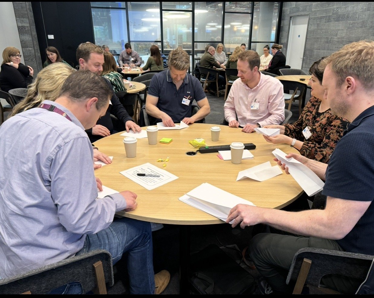 A cross-functional group mapping work together during a facilitated agile workshop